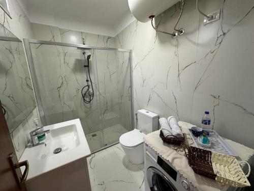 uma casa de banho com um chuveiro, um WC e um lavatório. em Sunset Sea View - Beachfront Balcony - AC - Wifi em Durrës