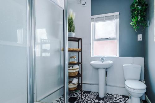 a bathroom with a toilet and a sink at Large 7 bedroom town house in Chester City Centre in Chester