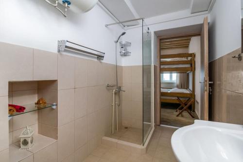 a bathroom with a shower and a sink and a toilet at Casa Della Zia in Plaka Milou