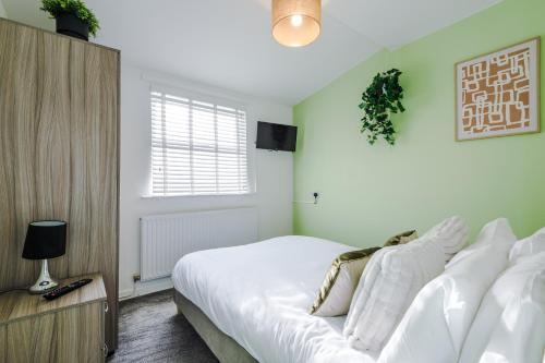 a bedroom with a white bed and a window at Large 7 bedroom town house in Chester City Centre in Chester