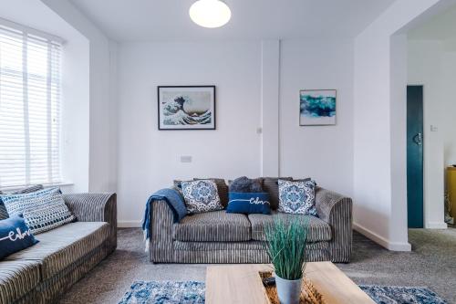 a living room with a couch and a table at Large 7 bedroom town house in Chester City Centre in Chester