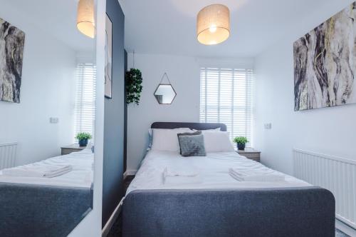 a bedroom with two beds and two windows at Large 7 bedroom town house in Chester City Centre in Chester