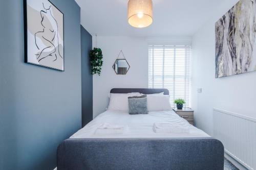 a bedroom with a bed in a blue room at Large 7 bedroom town house in Chester City Centre in Chester