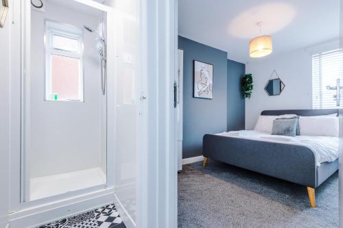 a small bedroom with a bed and a shower at Large 7 bedroom town house in Chester City Centre in Chester