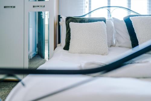 a white bed with pillows on it in a room at Large 7 bedroom town house in Chester City Centre in Chester