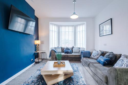 a living room with a couch and a table at Large 7 bedroom town house in Chester City Centre in Chester