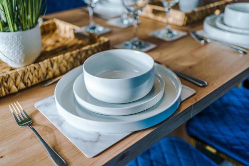 a wooden table with a cup and plates on it at Large 7 bedroom town house in Chester City Centre in Chester