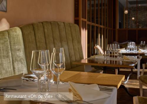 a dining room with wine glasses on a table at Lenkerhof gourmet spa resort - Relais & Châteaux in Lenk