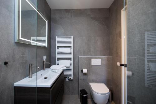 ein Bad mit einem Waschbecken und einem WC in der Unterkunft Vakantiehuis aan het water met hottub in Dokkum