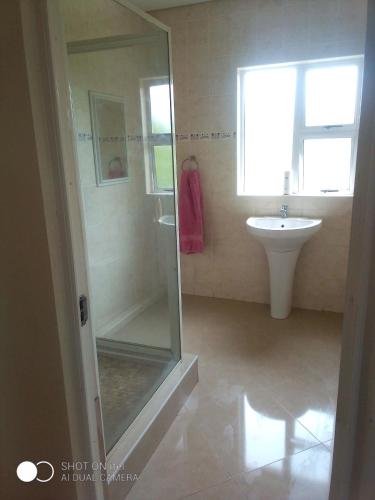 a bathroom with a glass shower and a sink at 3/45 Oxley Road in Port Edward
