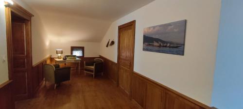 a hallway with a desk and a room with a table at Domaine les Garrigues in Puygaillard-de-Quercy