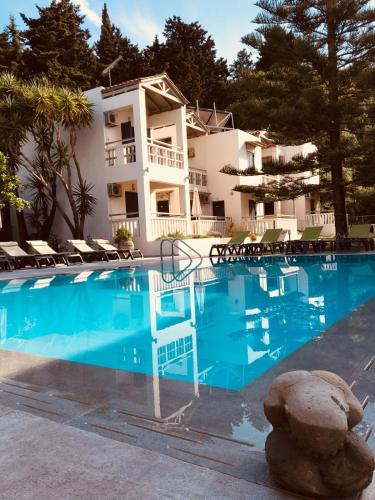 a large swimming pool in front of a house at Trianon Studios in Tsilivi