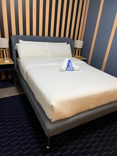 a large bed in a room with two tables at Modular Suites Alfonso Gómez in Madrid