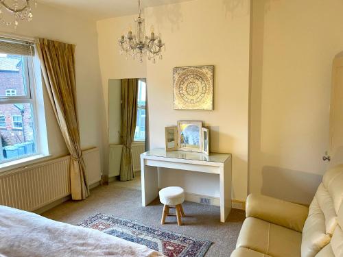 a bedroom with a desk with a picture on it at 48 South St in Alderley Edge