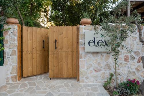 a fence with wooden gates with a sign on it at MAISON - ELEA in Ierissos