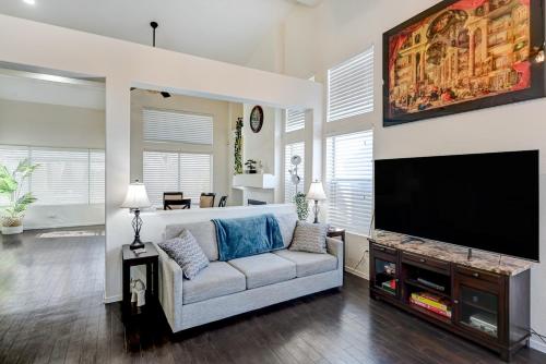 a living room with a couch and a flat screen tv at Chic Vegas Retreat: Near Top Attractions in Las Vegas