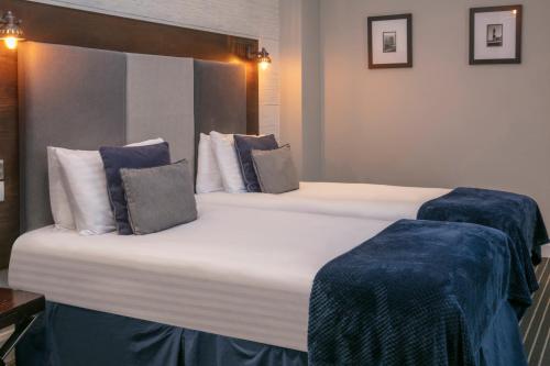 a large bed in a hotel room with two pillows at Roker Hotel BW Premier Collection in Sunderland