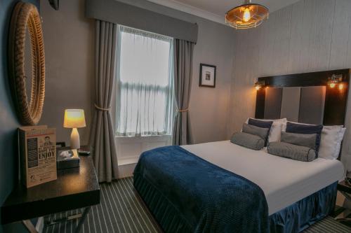 a hotel room with a large bed and a window at Roker Hotel BW Premier Collection in Sunderland