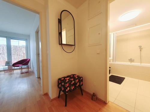 a bathroom with a mirror and a stool in a room at Near Lake One Bedroom Adorable Apartment in Vienna