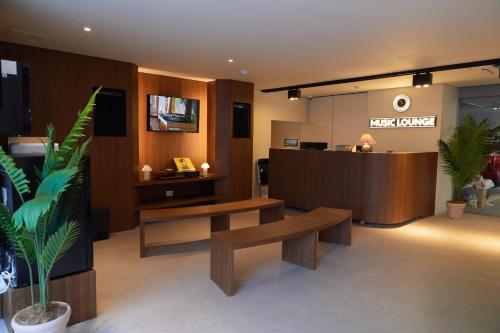 a waiting room with benches and a reception desk at Aank Hotel Suwon in Suwon