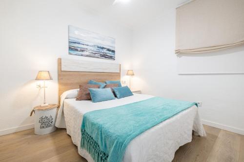 een slaapkamer met een groot bed met blauwe kussens bij Atalaya Sea View 6-9 in Finestrat
