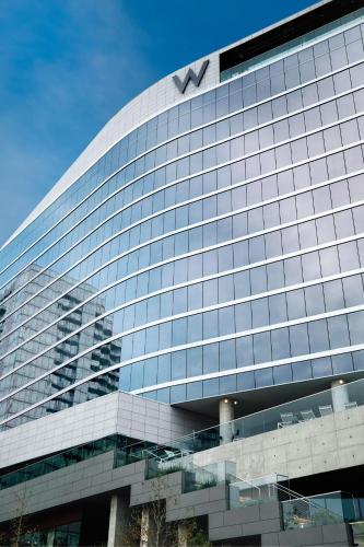 a large glass building with a sign on top of it at W Nashville in Nashville