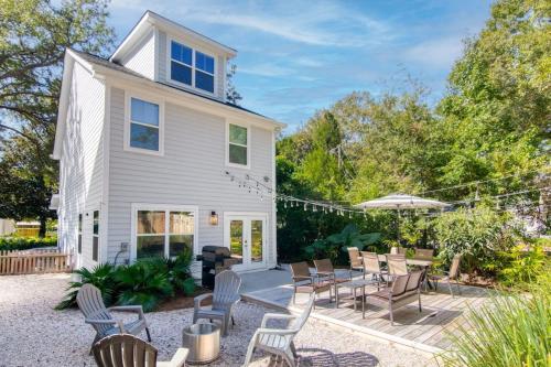 a white house with chairs and a patio at Lowcountry Lux 5 min to Beach 7 min to Dtwn in Charleston