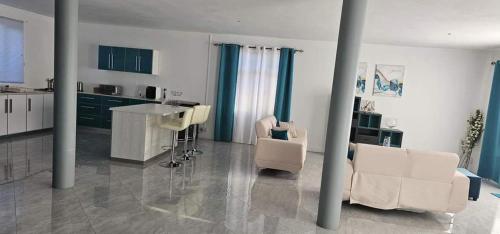 a kitchen with a table and chairs in a room at Lovely 3-Bed Villa in Goodlands Mauritius in Goodlands