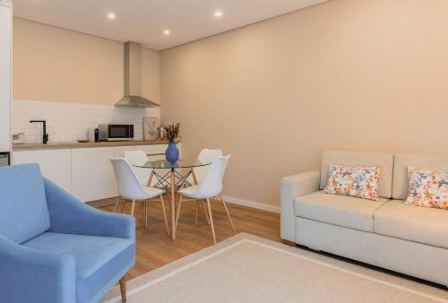a living room with a couch and a table at Primeiro Quartel Apartments - 1 in Peso da Régua