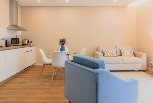 a living room with a couch and a table at Primeiro Quartel Apartments - 1 in Peso da Régua