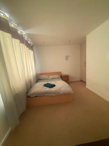 a bedroom with a bed with white curtains at Luxury double room in Nottingham