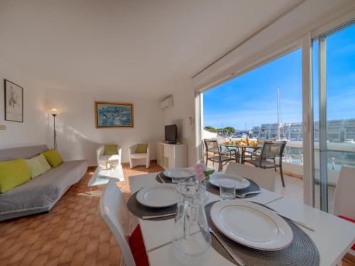 un salon avec une table et un canapé dans l'établissement Apartment Les Régates by Interhome, au Grau-du-Roi