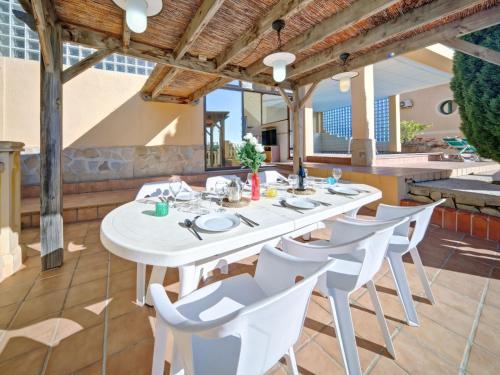 a white table and chairs on a patio at Apartment Raquel by Interhome in Calpe