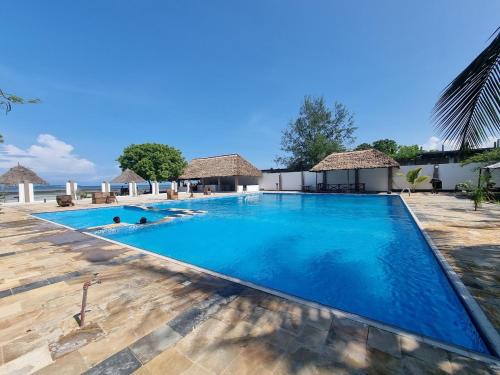 a view of a swimming pool at a resort at Kwa Mama Village Beach Resort in Dar es Salaam