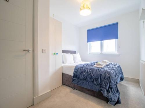 a small bedroom with a bed and a window at Pass the Keys Comfortable and Fabulous Family Home in Newton Mearns