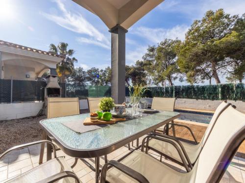 a table and chairs on the patio of a house at Holiday Home Gaviota 1 by Interhome in Riumar