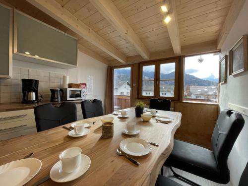 a kitchen and dining room with a wooden table and chairs at Apartment Eberhorn by Interhome in Garmisch-Partenkirchen