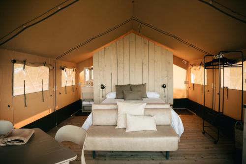 a bedroom with a large bed in a tent at ESPAZO NATURE in Carballo