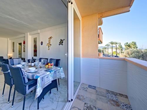 a dining table on a patio with a view of the ocean at Apartment L'Ancora by Interhome in Jávea