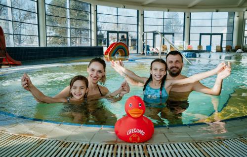 a group of people in a swimming pool with a rubber duck at Thermal Resort Hotel Lendava in Lendava