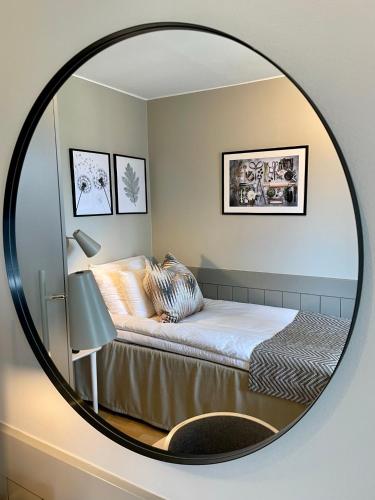 a mirror reflecting a bedroom with a bed and a bed at Runö Möten & Events in Åkersberga
