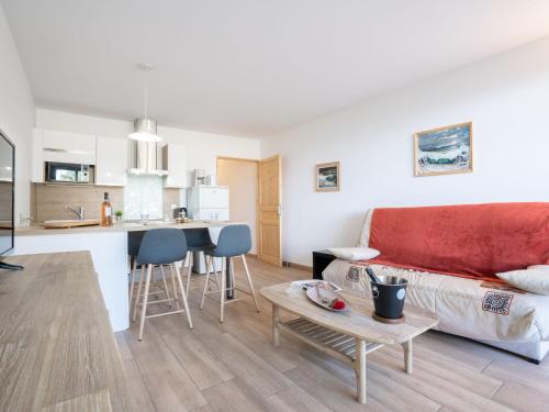 a living room and kitchen with a couch and a table at Apartment Les Louvans-2 by Interhome in Saint-Aygulf