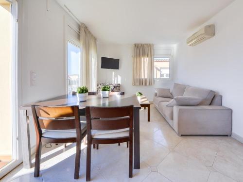 a living room with a table and a couch at Apartment Puigmal by Interhome in Empuriabrava