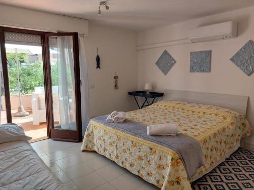 Una cama o camas en una habitación de Lido I Palmizi
