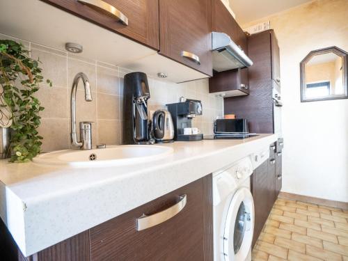a kitchen with a sink and a washing machine at Apartment Maures de l'Esterel-1 by Interhome in Saint-Aygulf