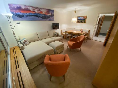un soggiorno con divano e tavolo di Apartment Promenade - Utoring-79 by Interhome a Arosa