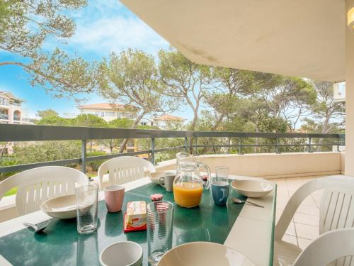 een tafel met eten en drinken op een balkon bij Apartment Le Grand Parc-6 by Interhome in Saint-Aygulf