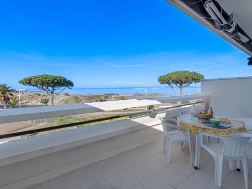 un balcon avec une table et une vue sur l'océan dans l'établissement Apartment Le Serpent de Mer-2 by Interhome, au Grau-du-Roi