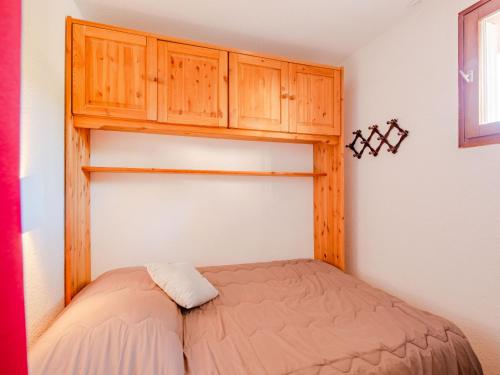 サント・マキシムにあるApartment Les Coteaux de la Nartelle-3 by Interhomeの小さなベッドルーム(ベッド1台、木製キャビネット付)