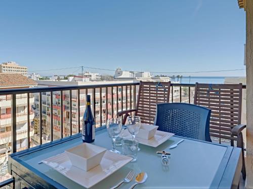 a table with glasses and a bottle of wine on a balcony at Apartment Galicia Javea-2 by Interhome in Jávea